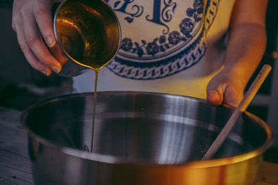 Cropped image of woman preparing food in kitchen