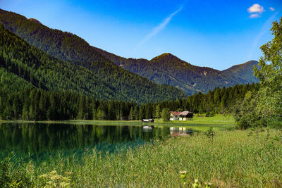 Scenic view of lake and mountains against sky