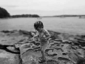 Cute boy standing on beach