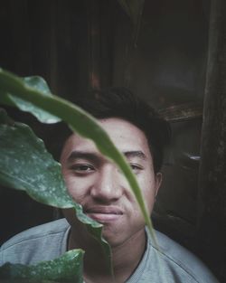 Close-up portrait of man looking by plants