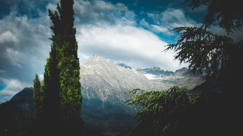 Scenic view of mountains against cloudy sky