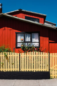 Red building against blue sky on sunny day