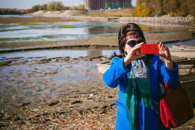 Portrait of girl photographing water