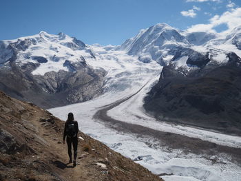 Full length of person on snowcapped mountain against sky