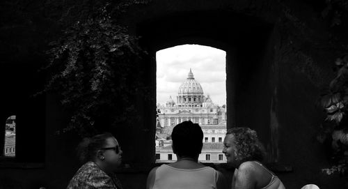 Rear view of woman looking at building