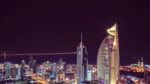 Illuminated buildings in city at night
