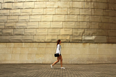 Rear view of woman walking outdoors
