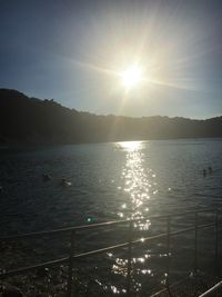Sun shining over lake