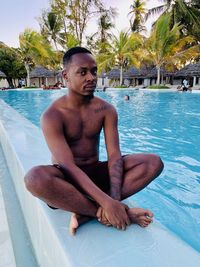 Portrait of young man swimming in pool