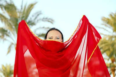 Portrait of woman wearing traditional clothing standing against sky