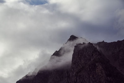 Low angle view of mountain range against sky