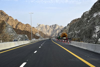 Road amidst mountains against sky