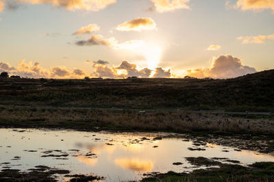 Scenic view of lake against sky during sunset