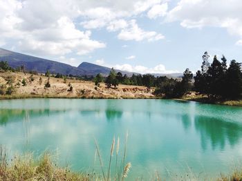 Scenic view of lake against cloudy sky