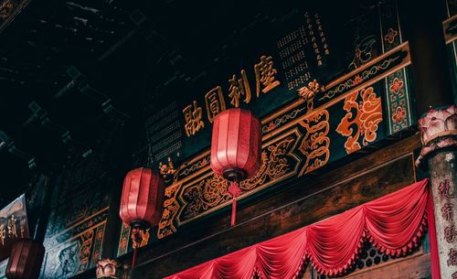 Low angle view of lanterns hanging outside house