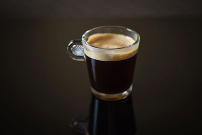 Close-up of coffee cup against black background