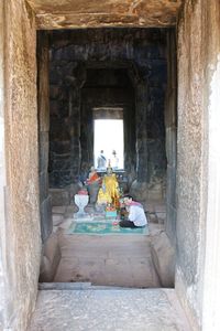 People sitting outside temple