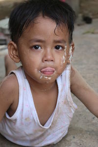 Close-up portrait of cute boy with messy face