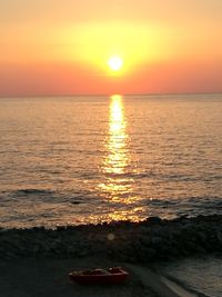 Scenic view of sea against romantic sky at sunset