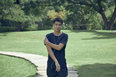 Portrait of young man standing in park