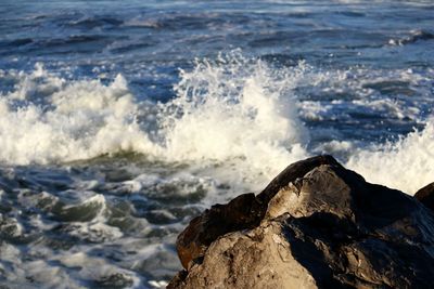 Waves breaking on rocks at beach
