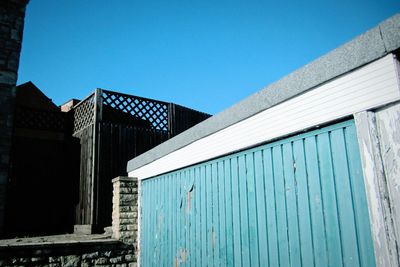 Low angle view of house against clear blue sky