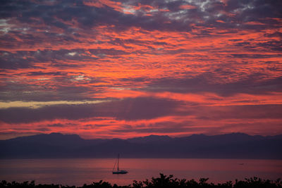 Scenic view of sea against orange sky