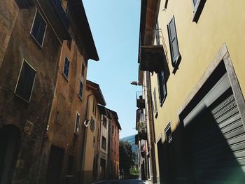 Alley amidst buildings during sunny day