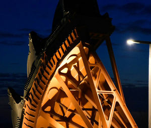 Low angle view of illuminated building against sky at dusk