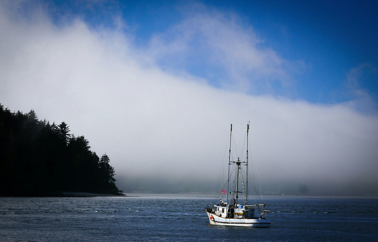 nautical vessel, transportation, water, mode of transport, boat, tranquil scene, sky, waterfront, sea, vacations, scenics, tranquility, mast, tourism, sailboat, nature, travel, sailing, beauty in nature, calm, cloud, cloud - sky, travel destinations, journey, majestic, non-urban scene, ocean, day, atmospheric mood, mountain