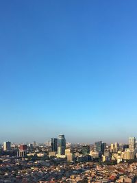 Cityscape against clear blue sky