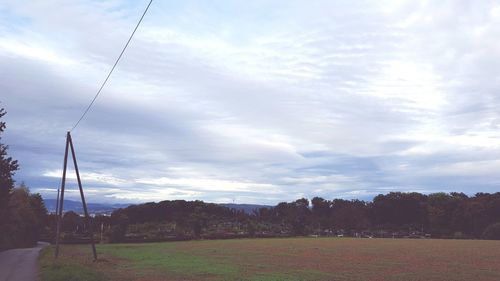 Countryside landscape against cloudy sky