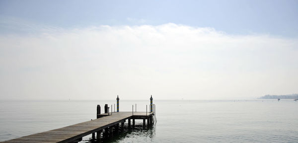 Pier over sea against sky