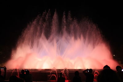 Low angle view of illuminated fountain against sky at night