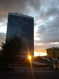 Buildings against cloudy sky at sunset