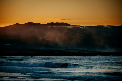 Scenic view of sea against sky during sunset