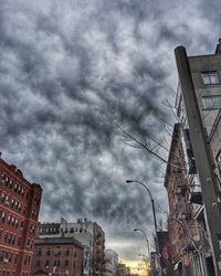 Low angle view of buildings against cloudy sky