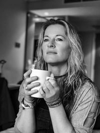 Close-up of mature woman drinking coffee at home