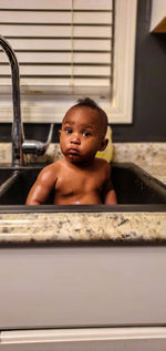 Portrait of shirtless boy looking away