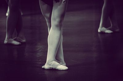 Low section of ballet dancers standing on stage