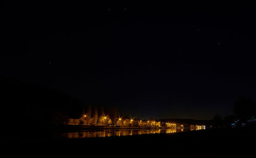 Scenic view of illuminated landscape against sky at night