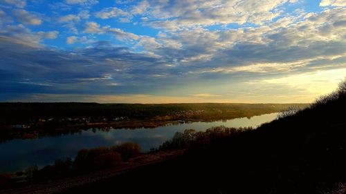 Scenic view of lake against sky at sunset