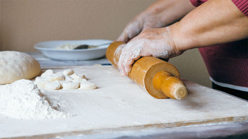 Midsection of man preparing food on table