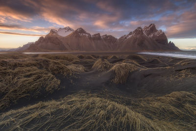 Scenic view of snowcapped mountains against sky during sunset