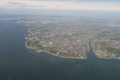 Aerial view of river amidst buildings in city