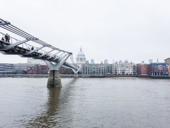 View of bridge over river against buildings