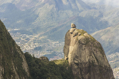 Rock formations on landscape against mountain range