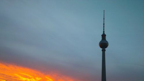 Low angle view of communications tower against sky