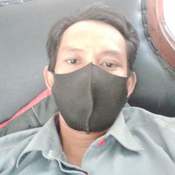 Close-up portrait of man covering face