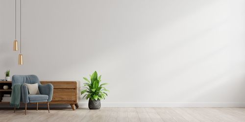 Empty chairs and table against wall at home